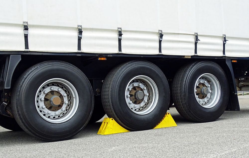 The Tyres of a Semi Truck Are Sitting on Yellow Blocks — BOEX Tyres And Performance in Bowral, NSW