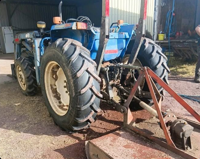 Blue Tractor With Large Rear Tyres Parked in a Shed — BOEX Tyres And Performance in Bowral, NSW