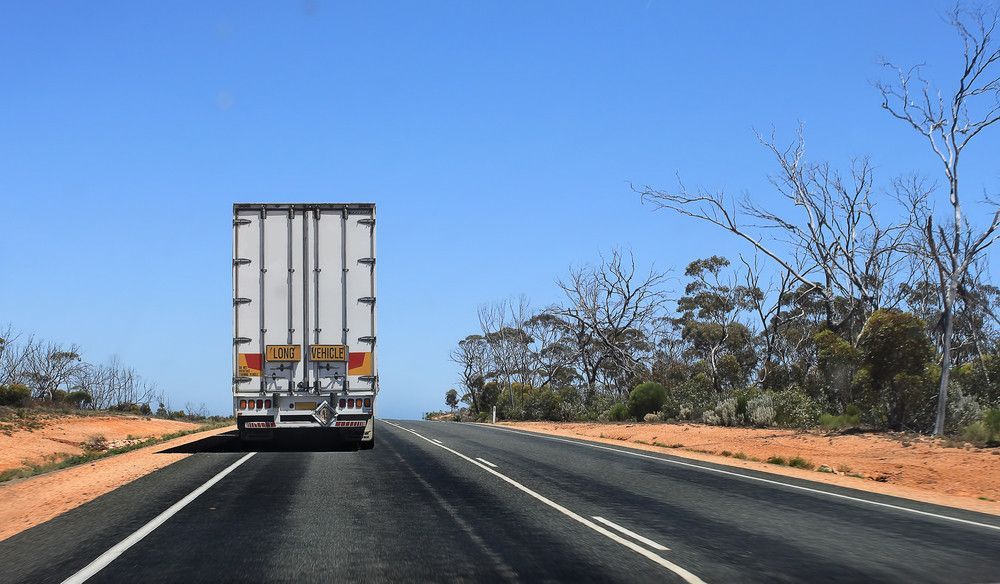 A Truck Is Driving Down A Highway — BOEX Tyres And Performance in Bowral, NSW