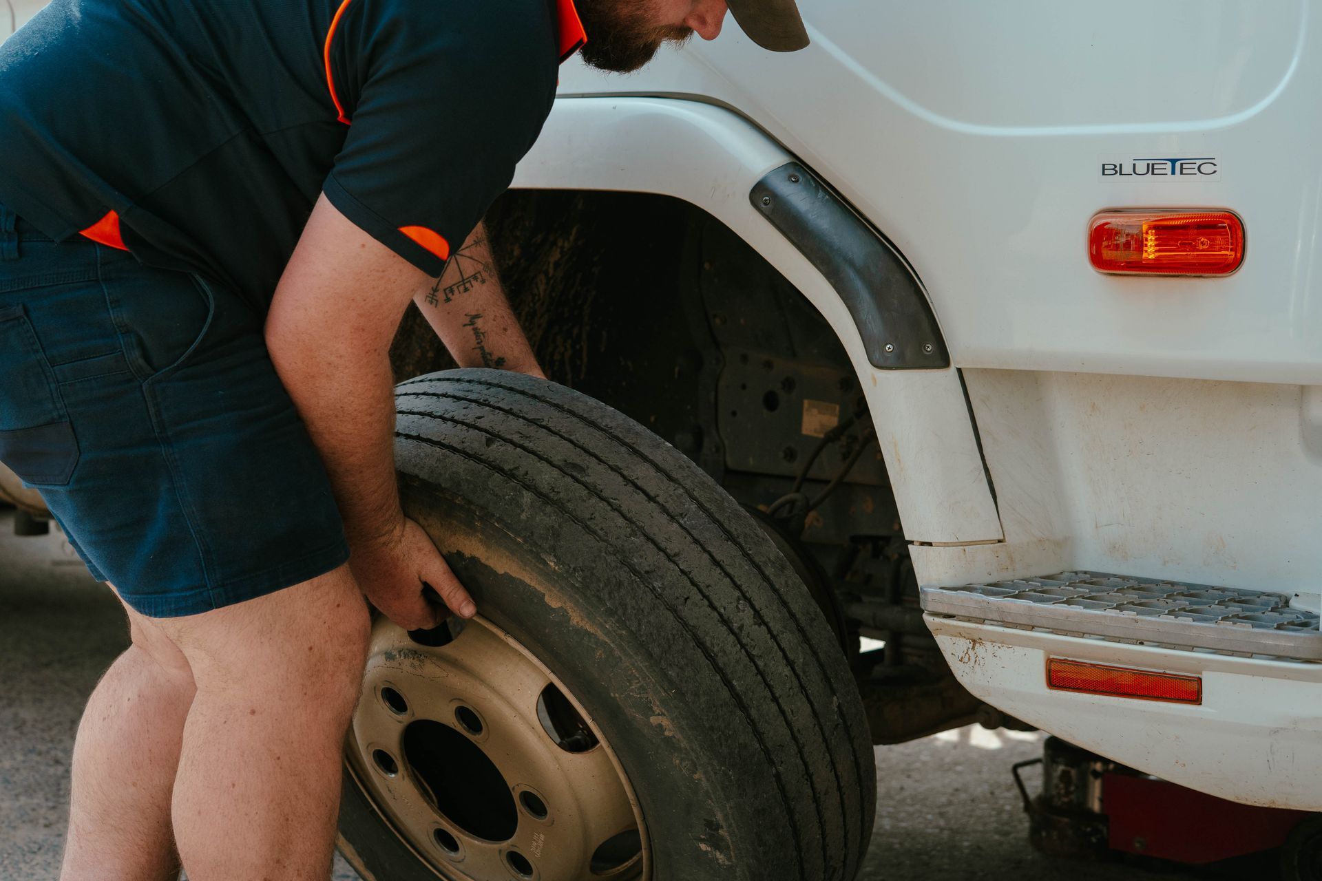 Person Changing a Truck Tyre on a White Vehicle — BOEX Tyres And Performance in Bowral, NSW