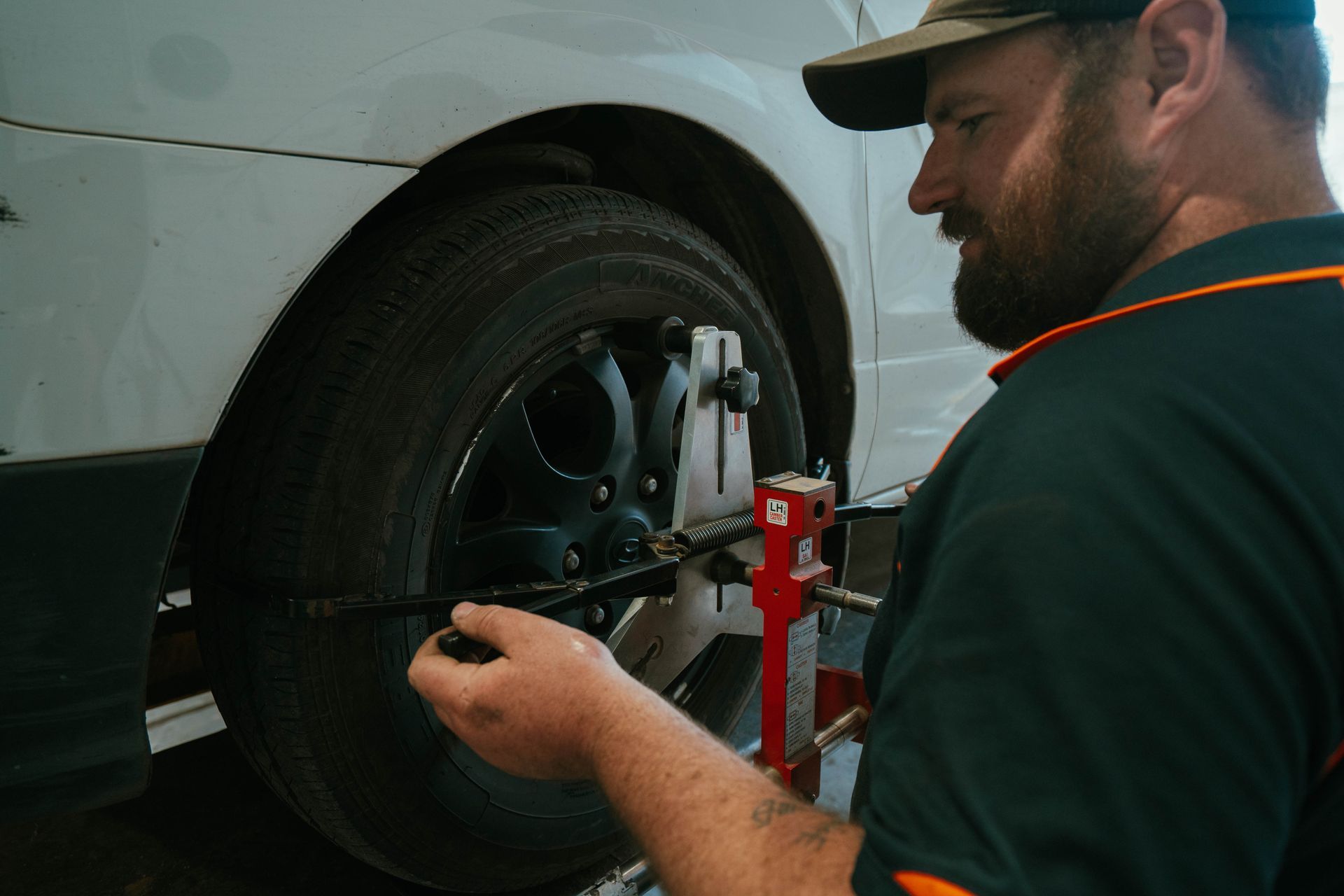 Mechanic Tightening Lug Nuts on a Car Wheel — BOEX Tyres And Performance in Bowral, NSW