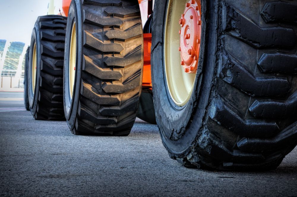 Large Tractor Tyres Lined Up on Pavement — BOEX Tyres And Performance in Bowral, NSW