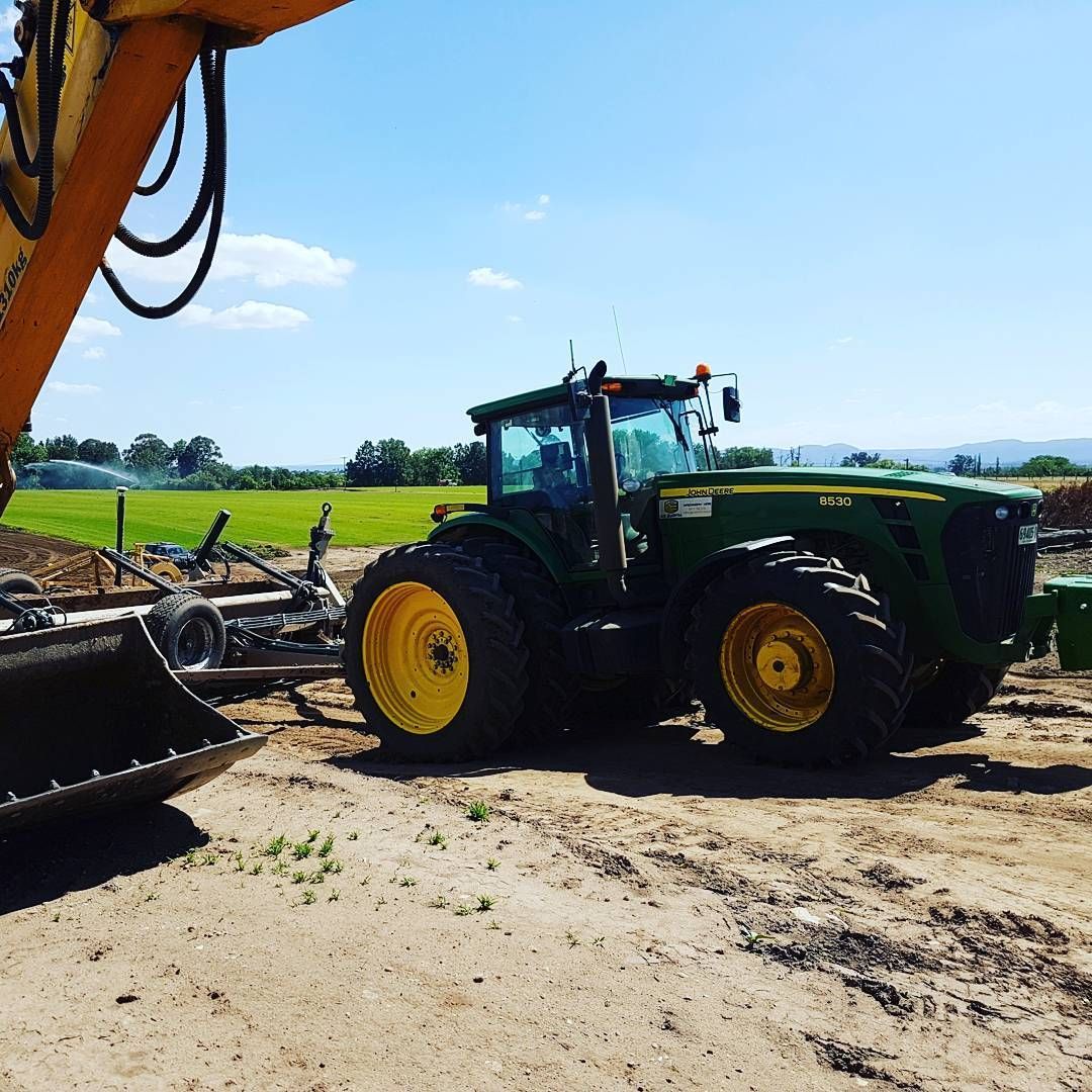 Green Tractor With Yellow Wheels Parked Beside Farm Machinery — BOEX Tyres And Performance in Bowral, NSW