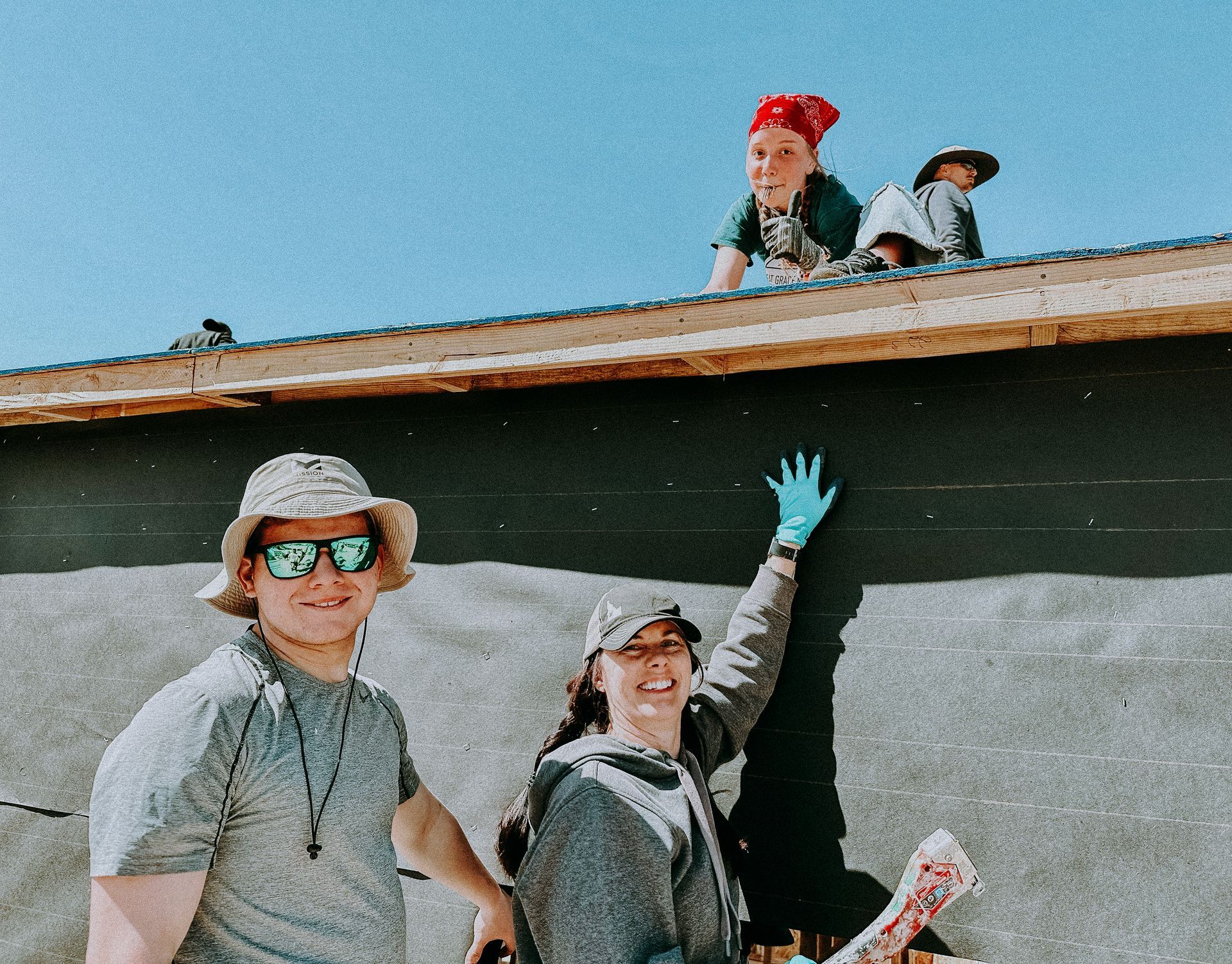 A man and a woman are standing next to each other on a roof.