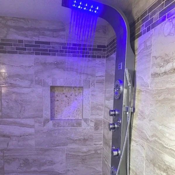 Modern tiled shower with blue LED rainfall showerhead and chrome fixtures