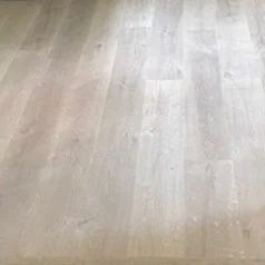 Light wood floor with a pale beige and gray grain pattern