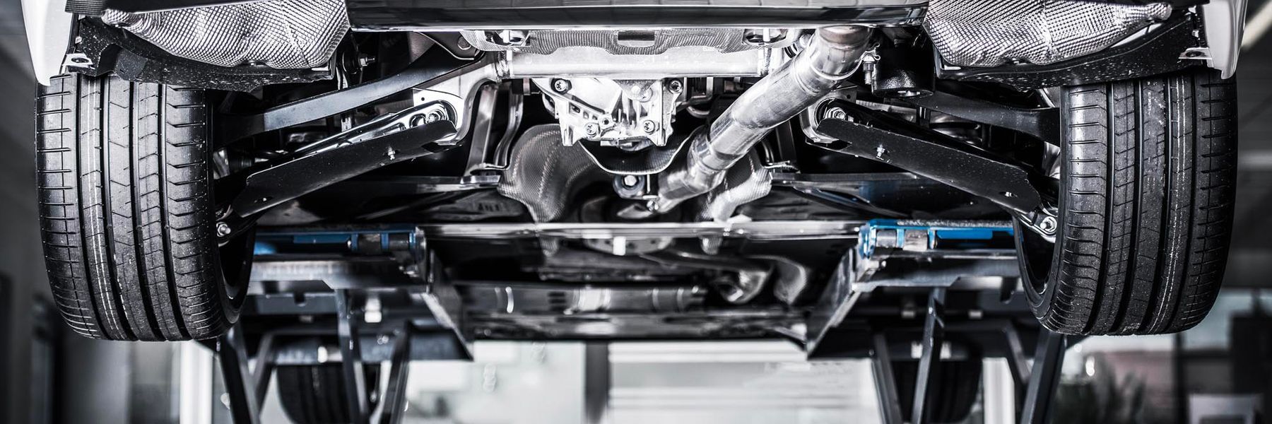 A man is working on the engine of a car.