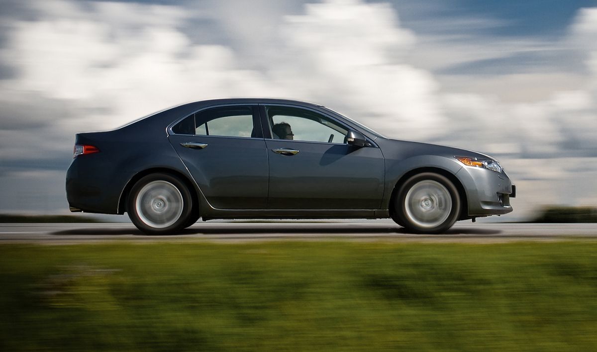 a car is driving down a road on a cloudy day .