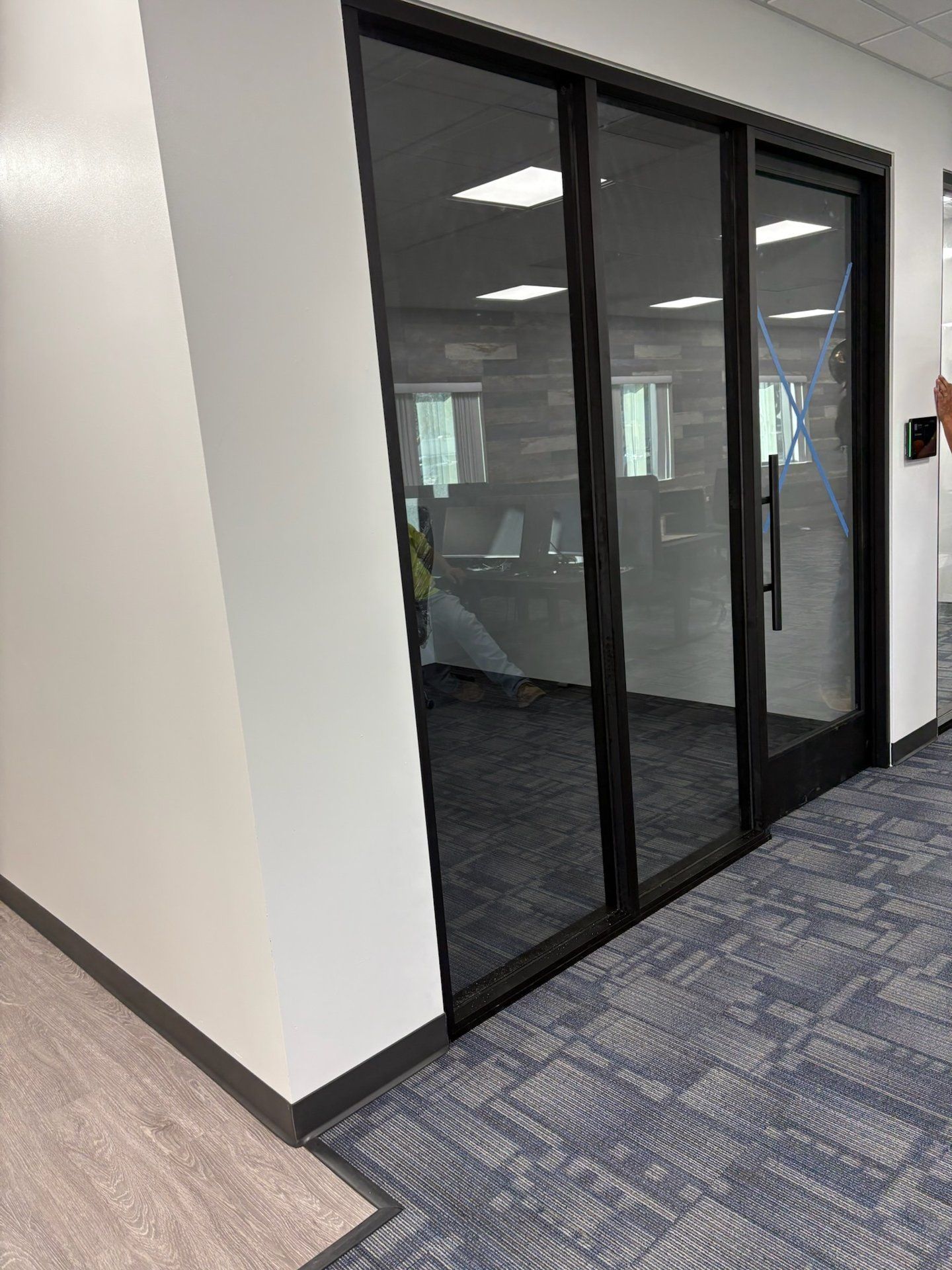 Black aluminum interior storefront glass office doors by High Desert Window and Glass
