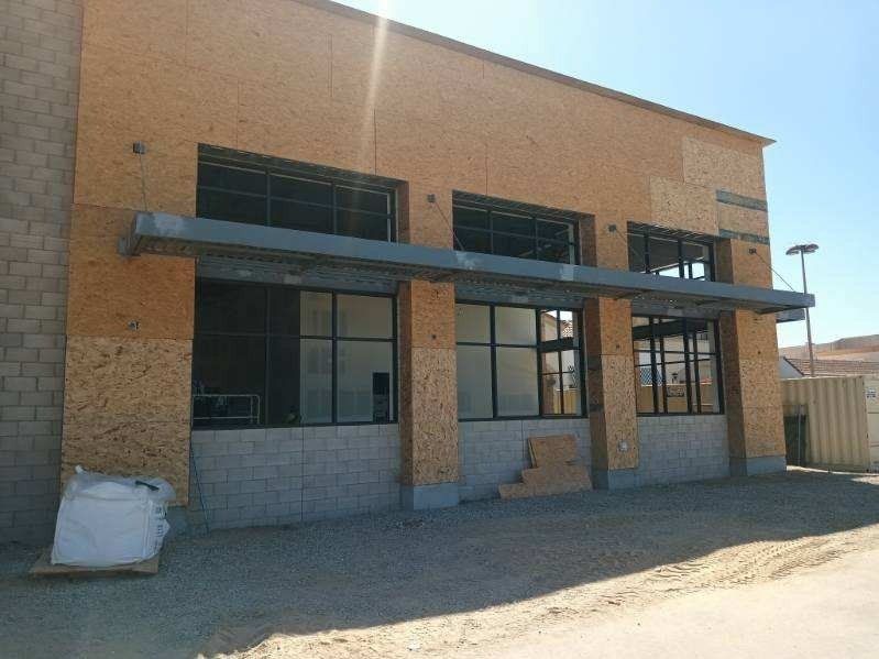 Commercial aluminum storefront windows under awning installed by High Desert Window and Glass