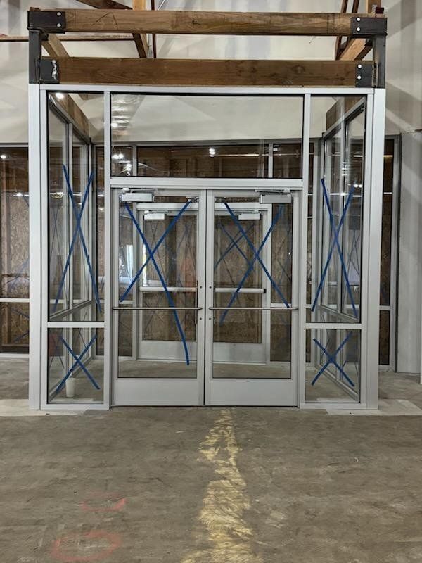 Aluminum storefront vestibule with double glass entry doors by High Desert Window and Glass