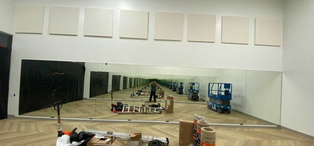 Custom wall mirror installation in a commercial studio by High Desert Window and Glass