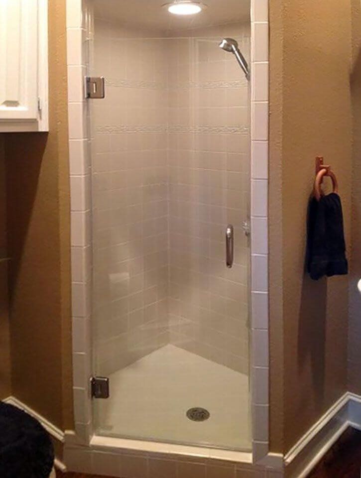 Hinged glass shower door with brushed nickel hardware by High Desert Window and Glass