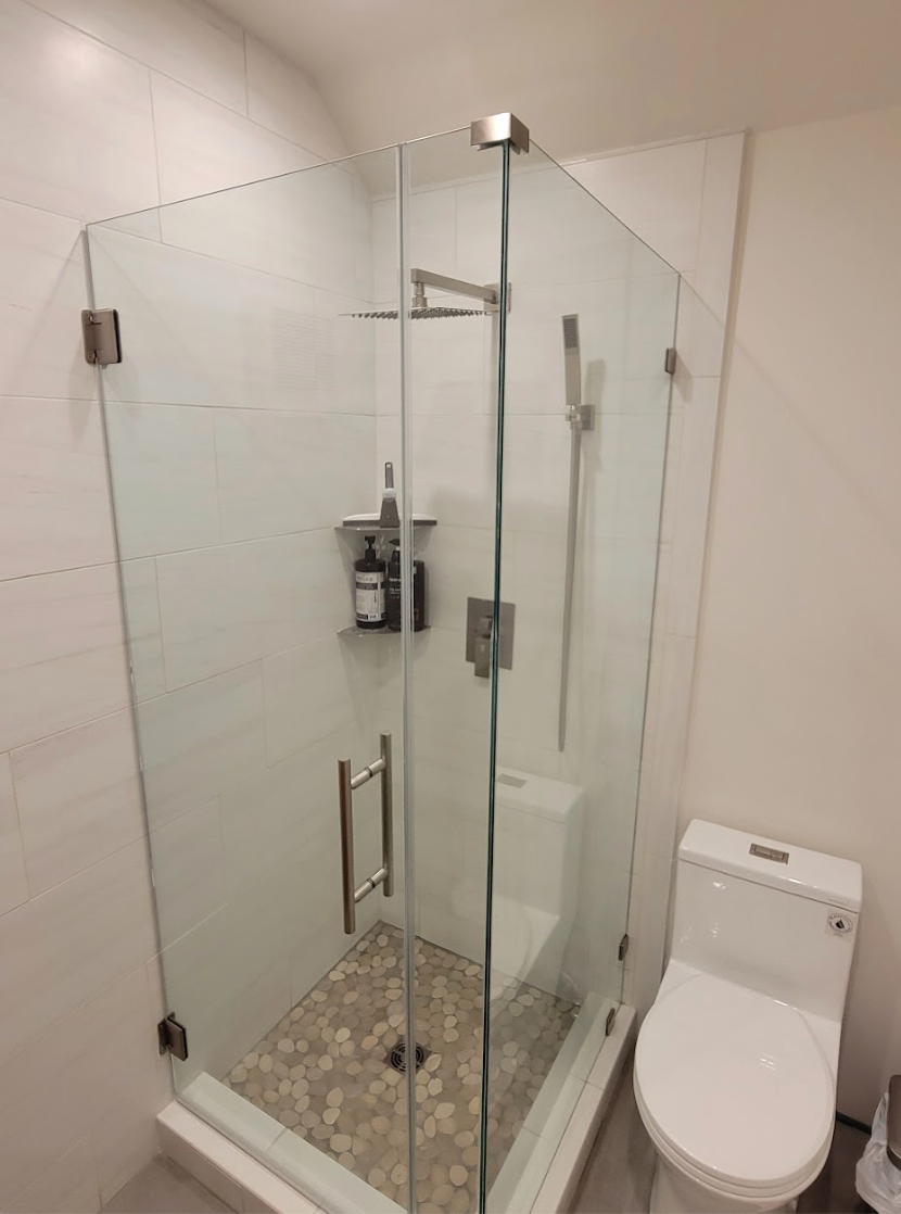 Frameless corner glass shower enclosure with brushed nickel ladder pull by High Desert Window and Glass