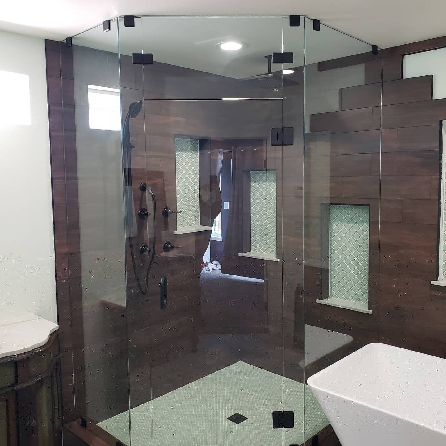 Frameless neo angle glass shower with wood-look tile