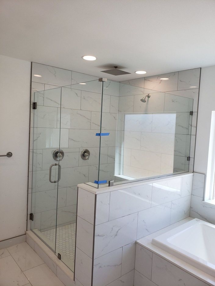 Frameless glass shower enclosure with knee wall installed in Victorville CA by High Desert Window and Glass