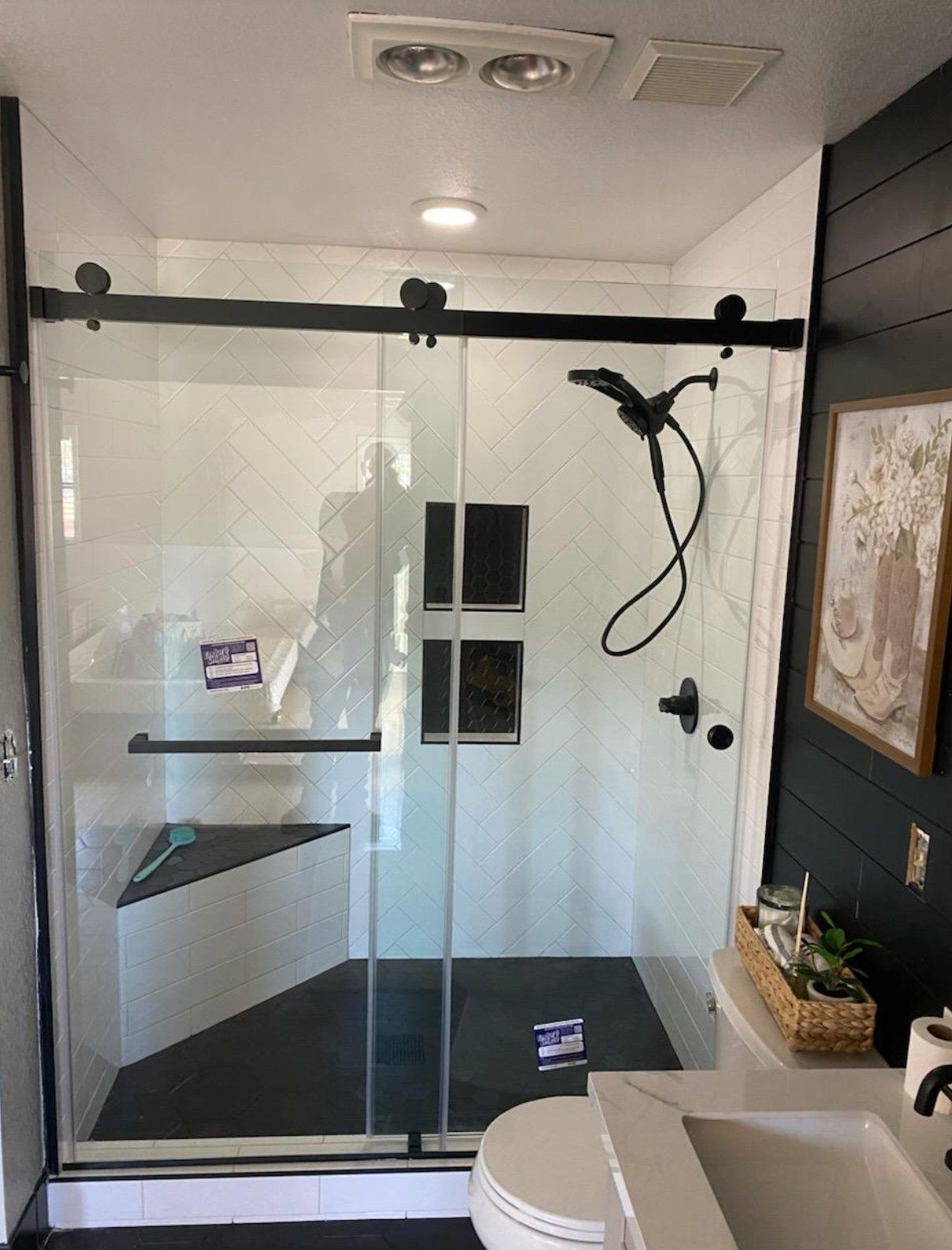 Frameless sliding shower door with matte black rolling hardware