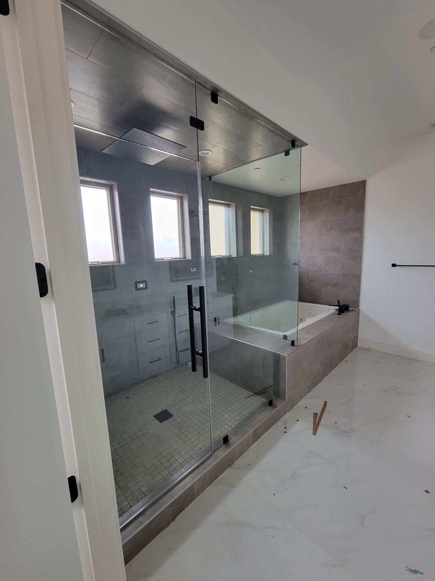 Frameless steam shower enclosure with glass transom in Victorville, CA