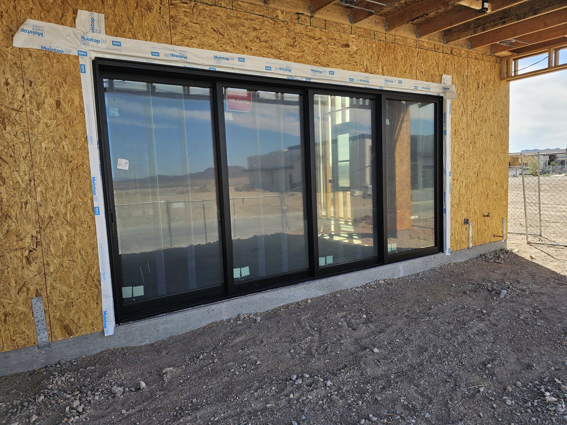 Milgard AX650 black sliding glass door installed in new construction by High Desert Window and Glass