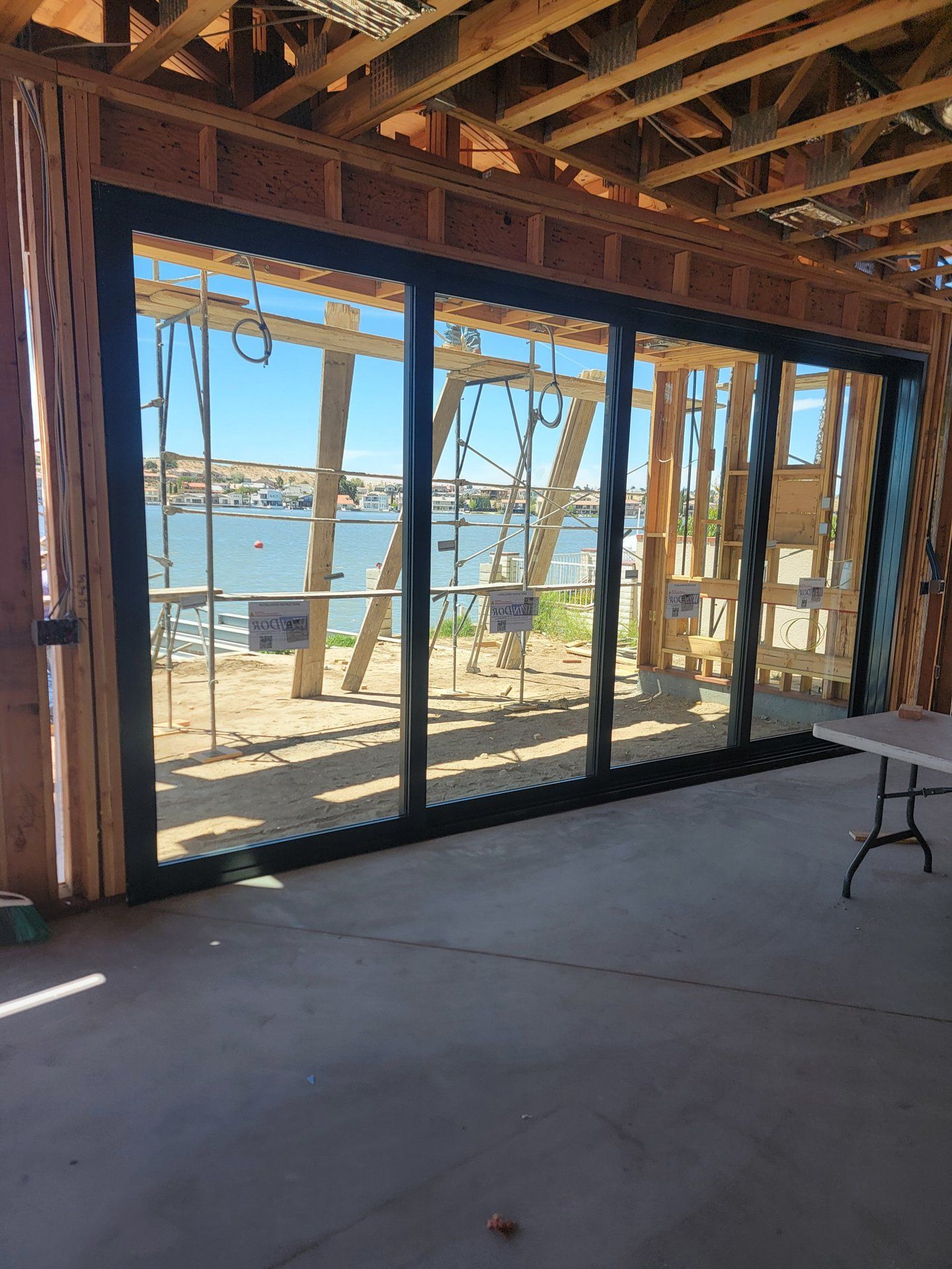 Milgard AX650 black sliding patio door with lake view installed by High Desert Window and Glass
