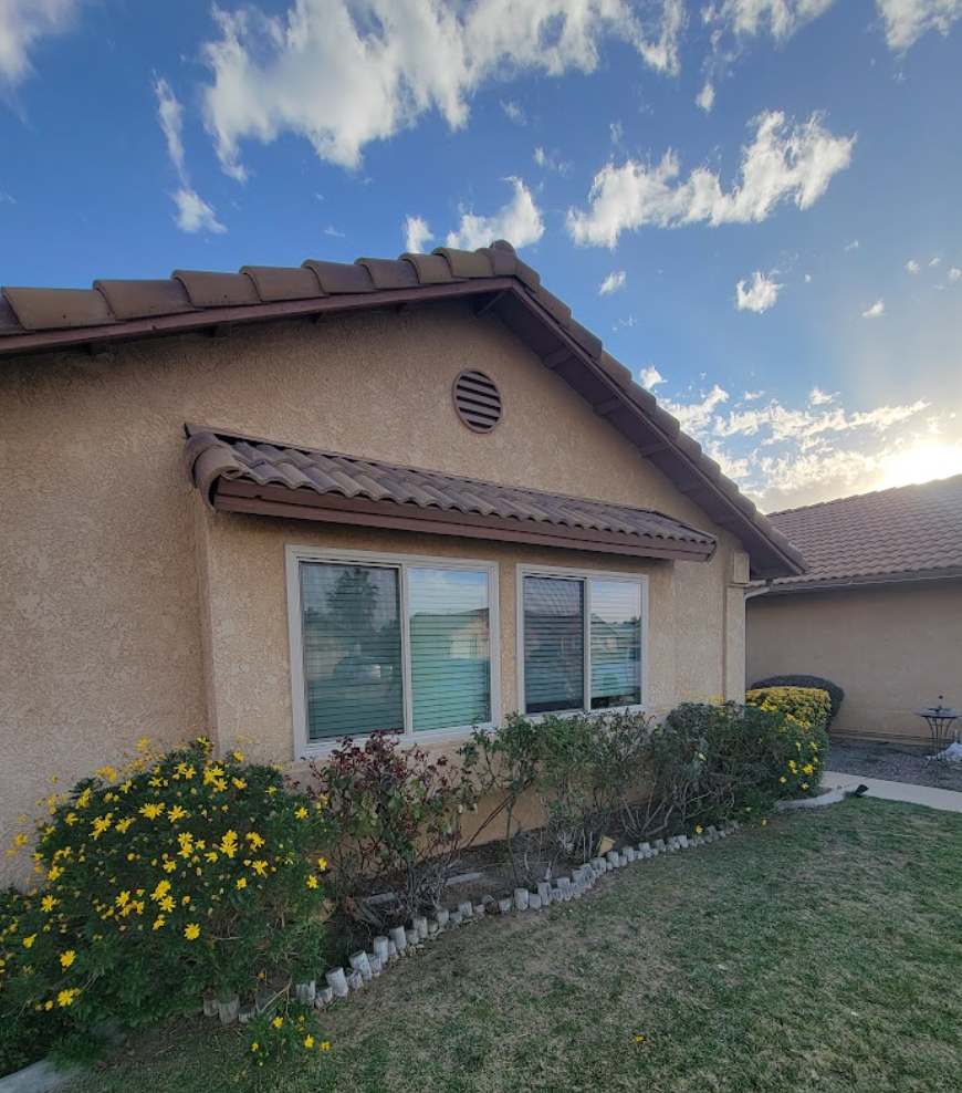 White-frame replacement windows on a stucco home with tile roof in the High Desert