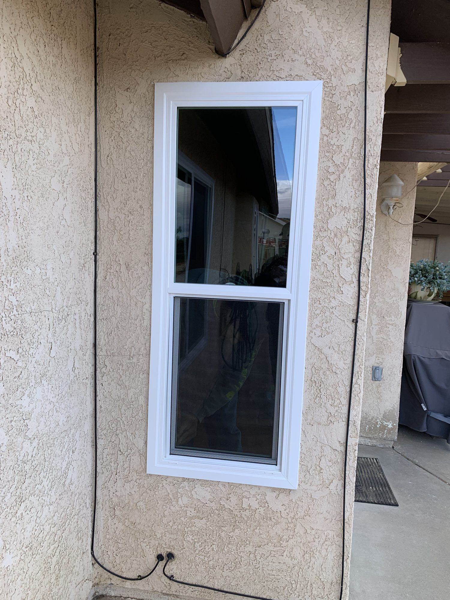 White vinyl retrofit single-hung window installed in a High Desert home