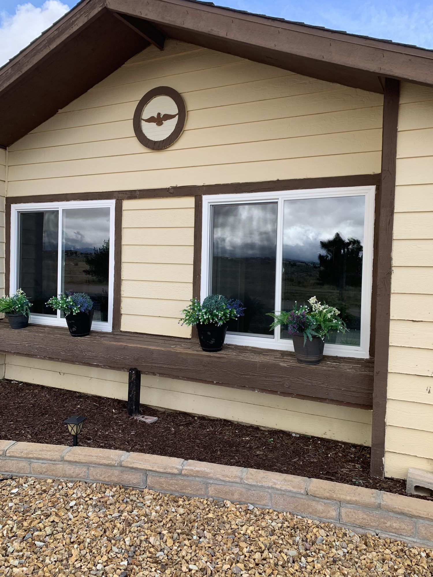 White vinyl retrofit slider windows in lap siding installed by High Desert Window and Glass
