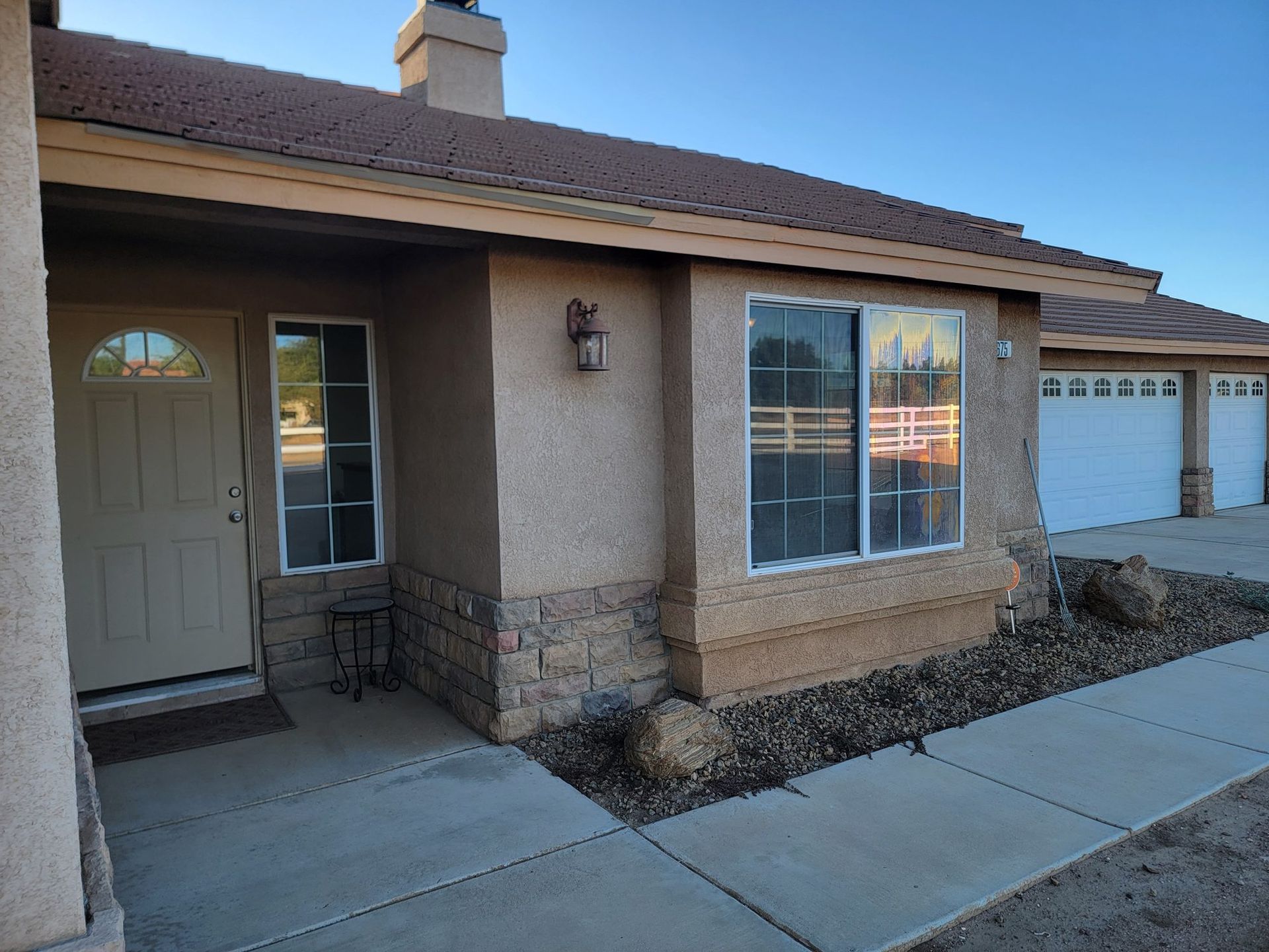 White vinyl retrofit windows on a stucco home front elevation by High Desert Window and Glass