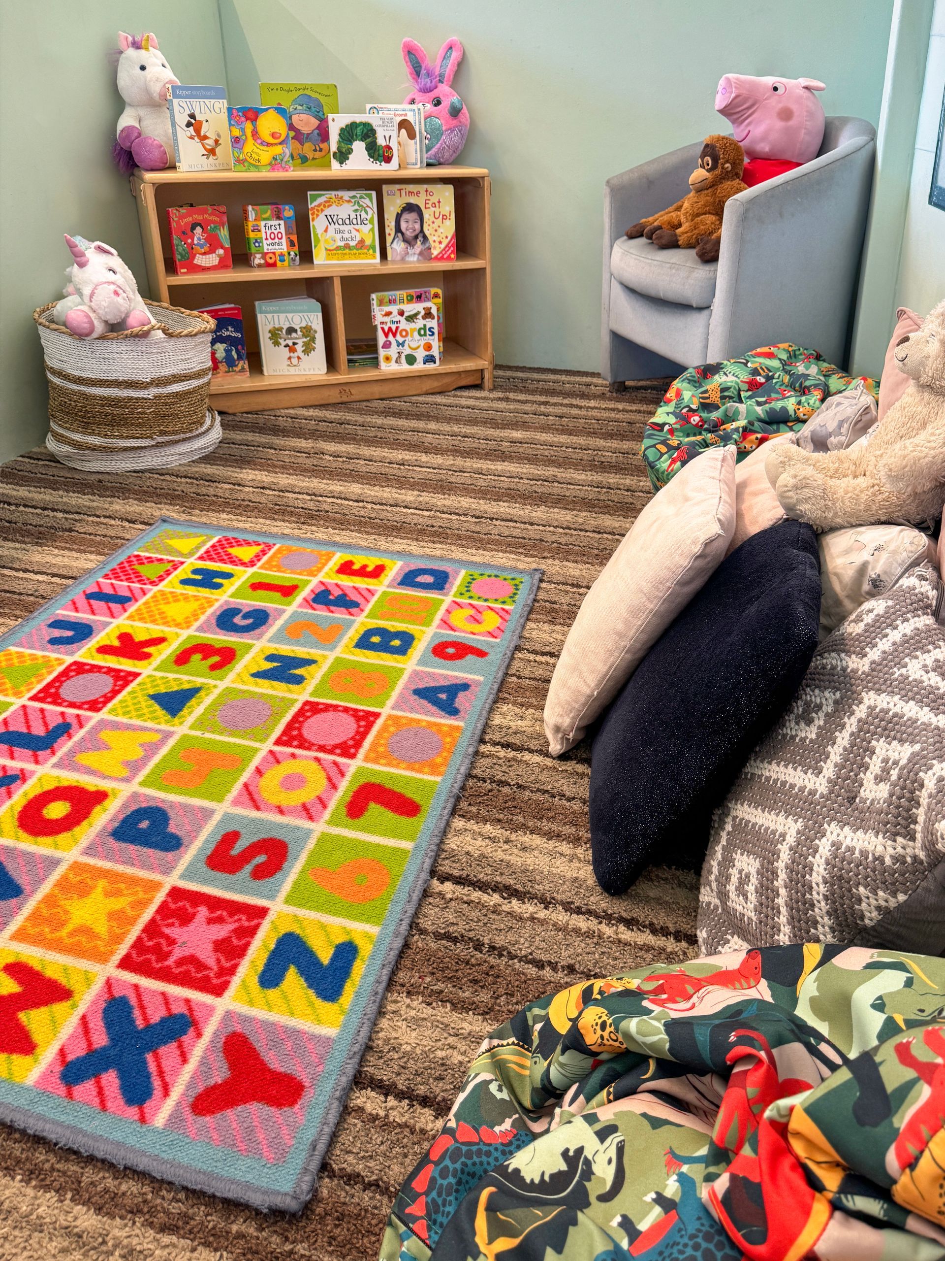 Cosy nursery reading corner with books and soft seating