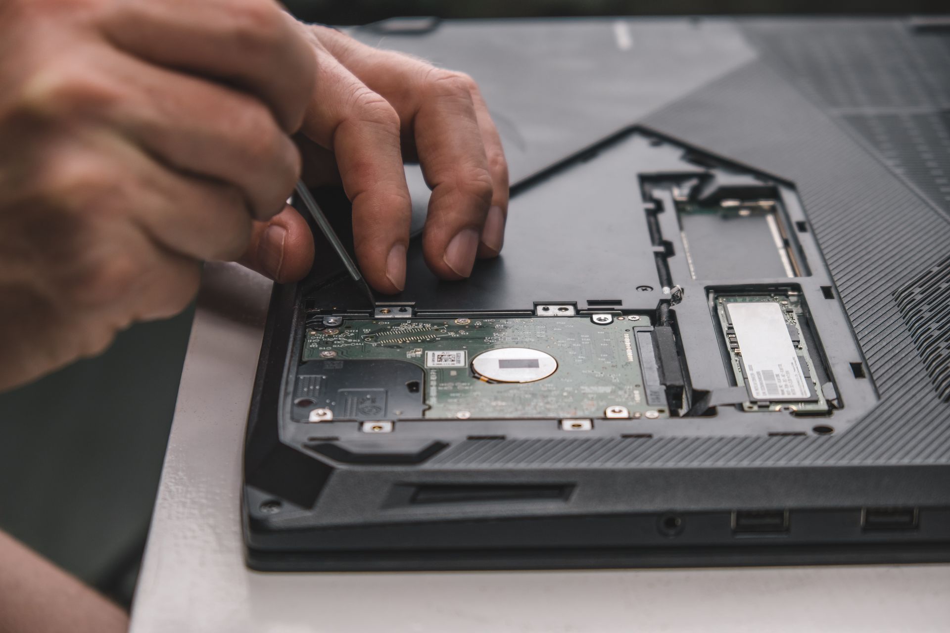 Technician testing a refurbished laptop at Lexington Computer Recycling in Versailles, KY