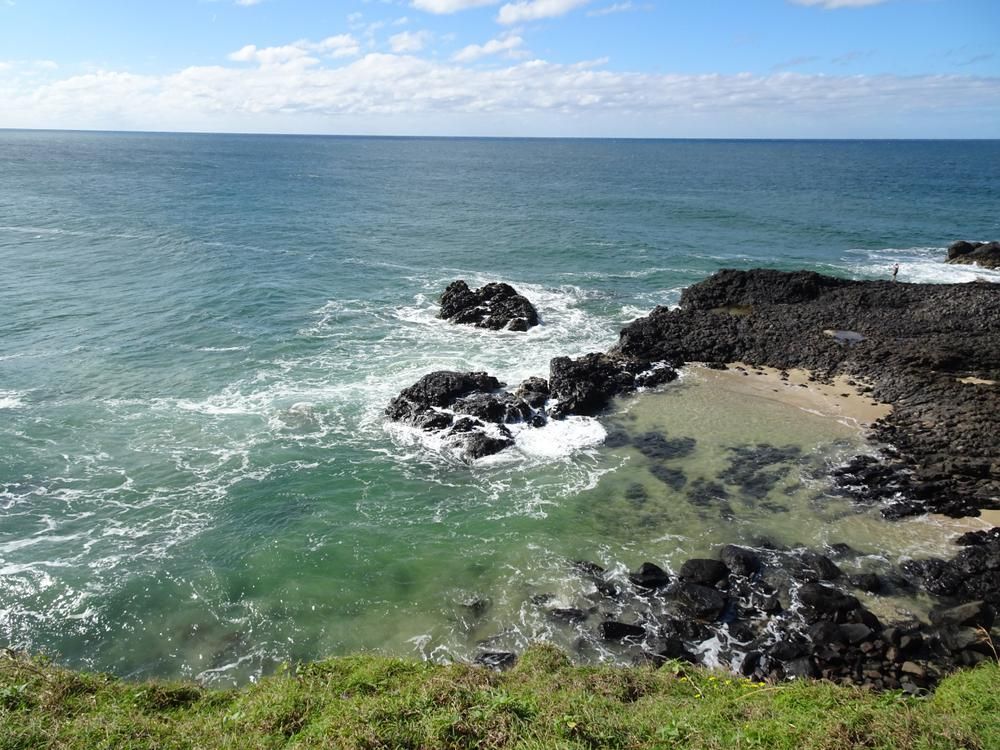 A View of The Ocean from A Cliff with Rocks in The Foreground — Lighthouse Pest Control In Lennox Head, NSW