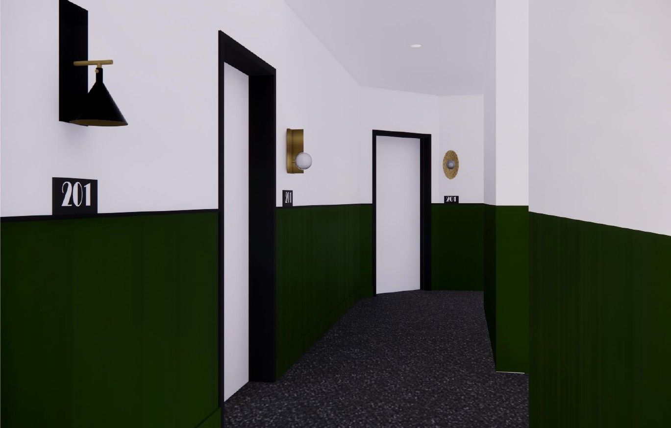 Hallway with white walls, dark green wainscoting, black floor, and two open doors leading ahead.
