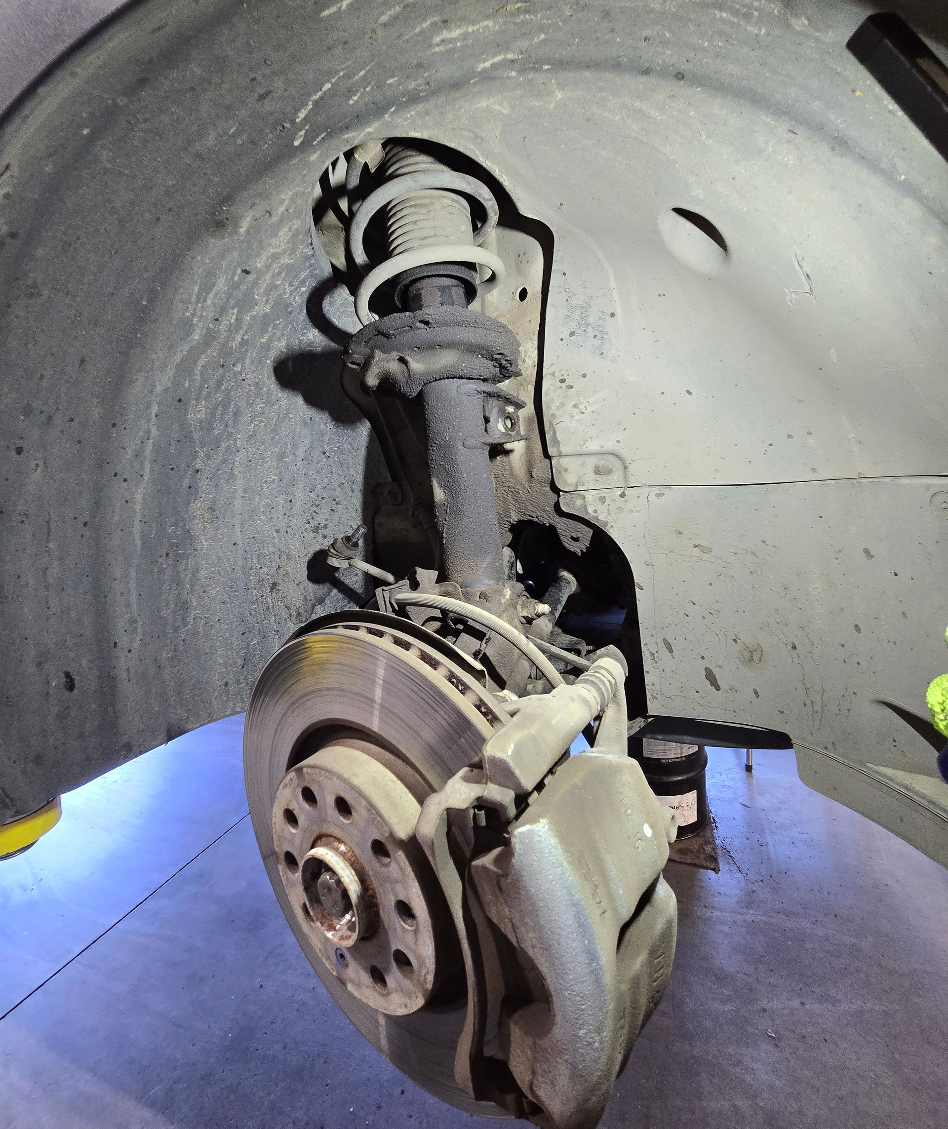 Worn front strut on a 2017 Volkswagen Golf Alltrack inspected at Peak Euro in Bend, Oregon