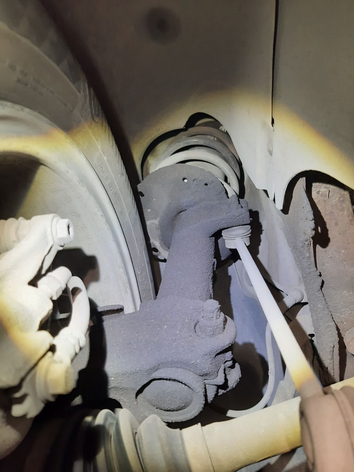 Worn front strut on a 2017 Volkswagen Golf Alltrack inspected at Peak Euro in Bend, Oregon