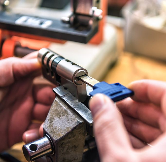 A Person Is Working on A Lock with A Key — Toowoomba Locksmiths in Toowoomba City, QLD