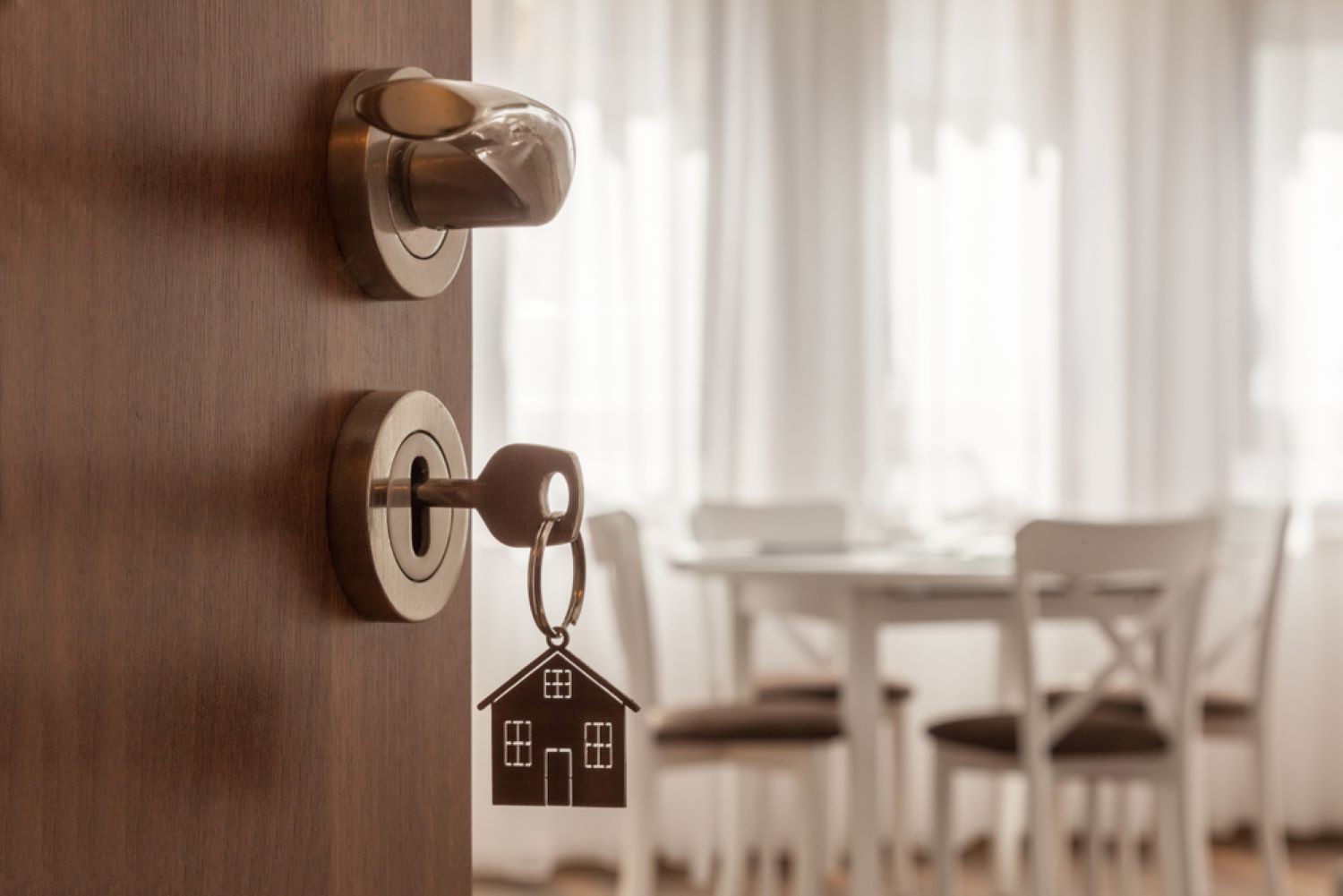 A Door with A Key in It and A Keychain — Toowoomba Locksmiths in Warwick, QLD