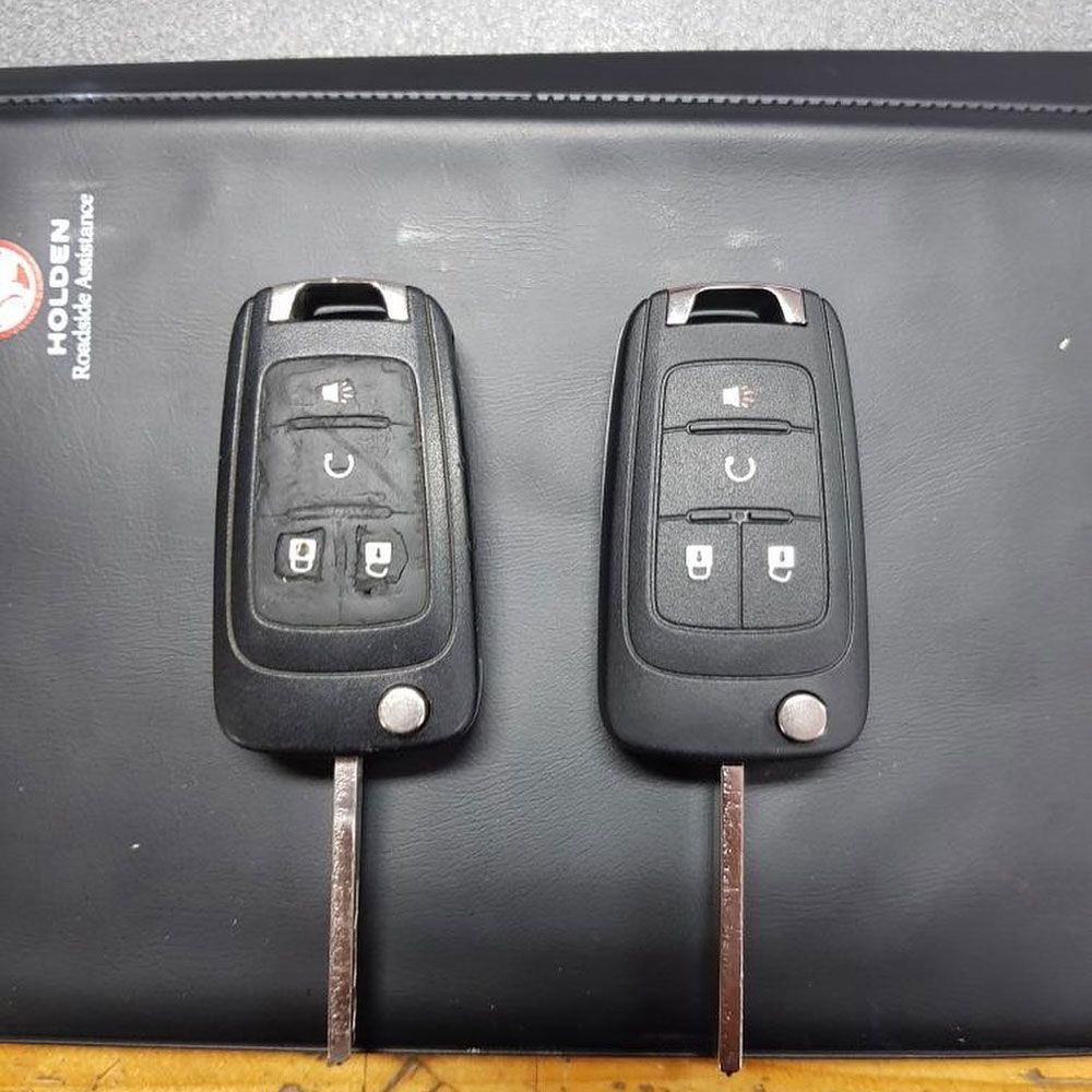 Two Car Keys Are Sitting on Top of A Black Pad — Toowoomba Locksmiths in Toowoomba City, QLD