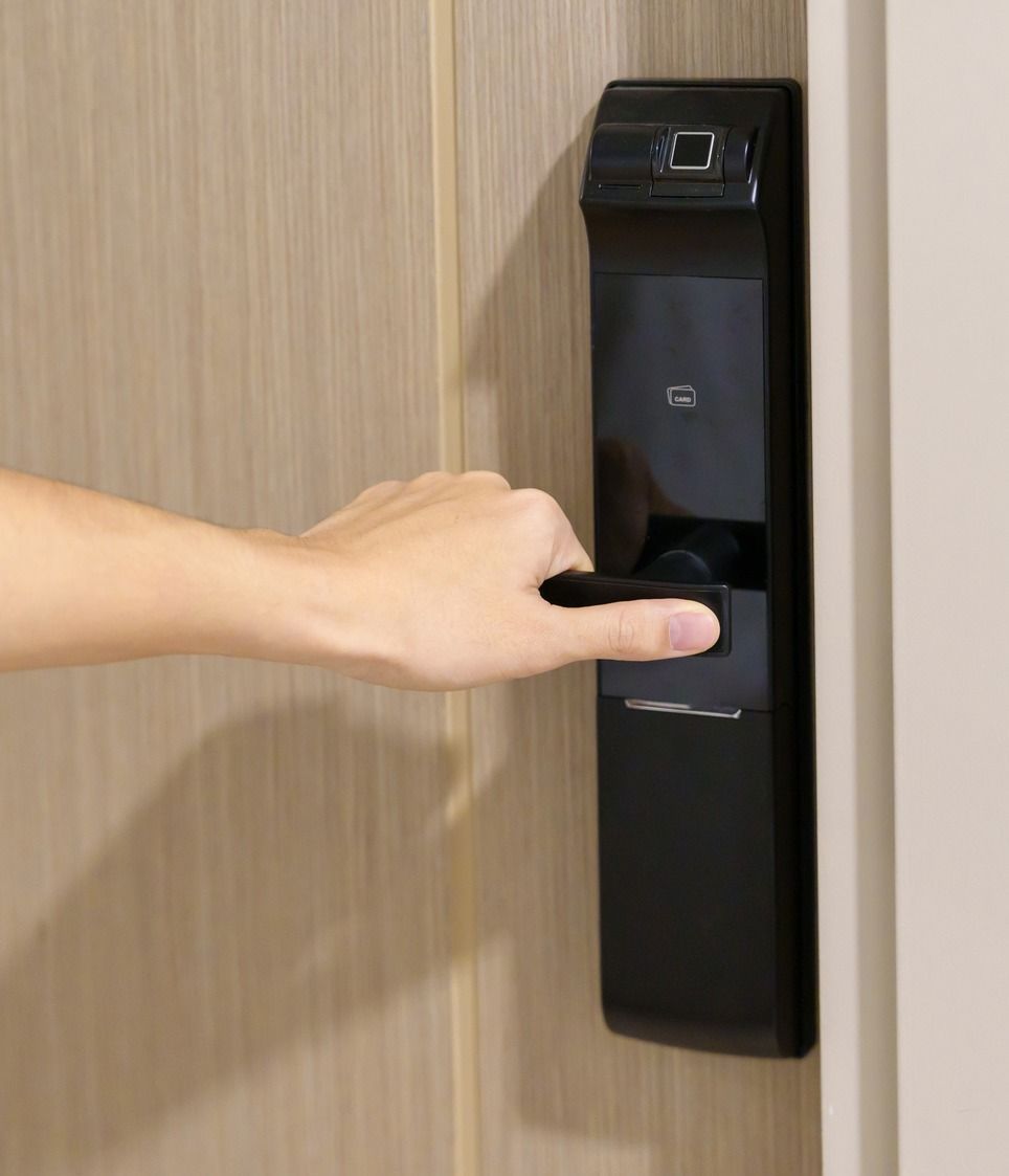 A Person Is Pressing a Button on A Door Lock — Toowoomba Locksmiths in Toowoomba City, QLD