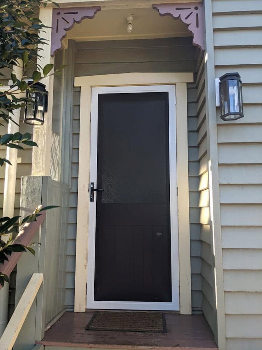Front Door With White Trim, Dark Screen Door, and Porch Steps on a House — Toowoomba Locksmiths in Toowoomba City, QLD