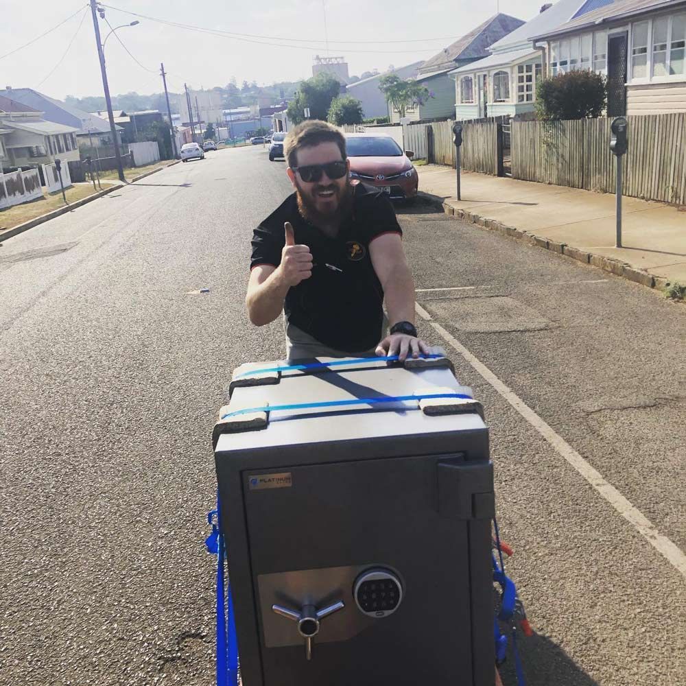 A Man Is Working with Safes — Toowoomba Locksmiths in Toowoomba City, QLD