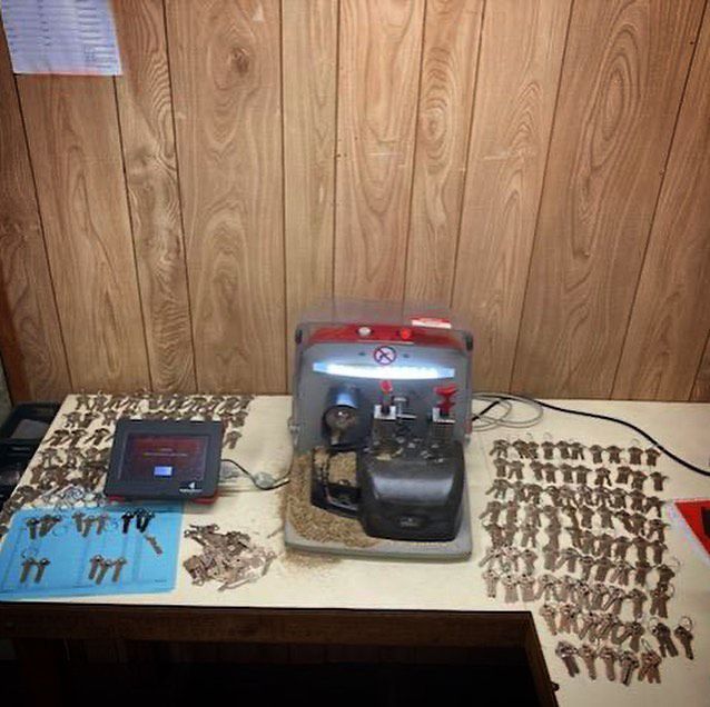 A Key Cutting Machine Is Sitting on A Table — Toowoomba Locksmiths in Toowoomba City, QLD