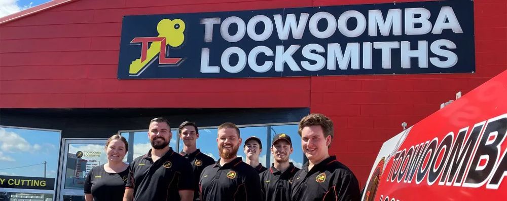 Group of People Standing in Front of A Toowoomba Locksmiths Building — Toowoomba Locksmiths in Toowoomba City, QLD