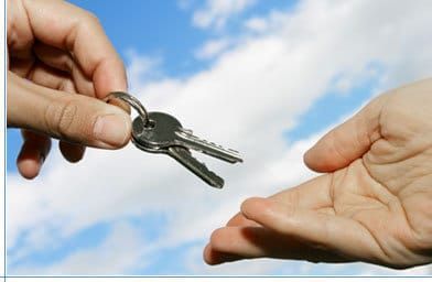 Person Is Handing a Pair of Keys — Toowoomba Locksmiths in Toowoomba City, QLD