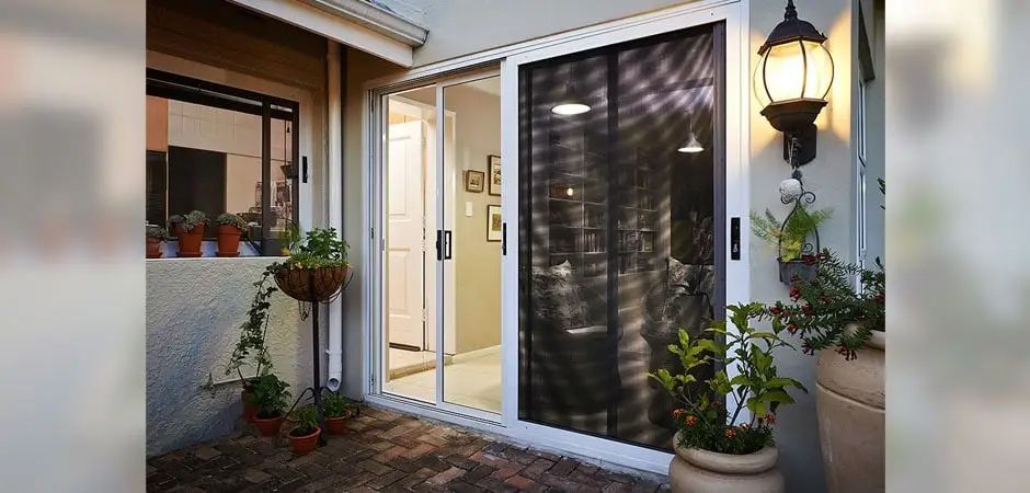 Patio with A Sliding Glass Door and Potted Plants — Toowoomba Locksmiths in Toowoomba City, QLD