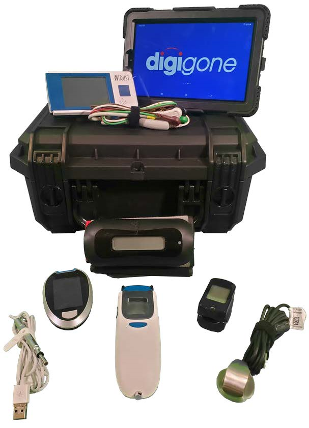 A picture of the digiMed Standard telemedicine kit, with its numerous medical devices, mostly wireless, laid out in front of the kit's case. The following devices are shown: The tablet, an ECG device and its wires, a blood pressure cuff, a blood glucose meter, a wired stethoscope, a thermometer, a pulse oximeter, and a wired stethoscope.