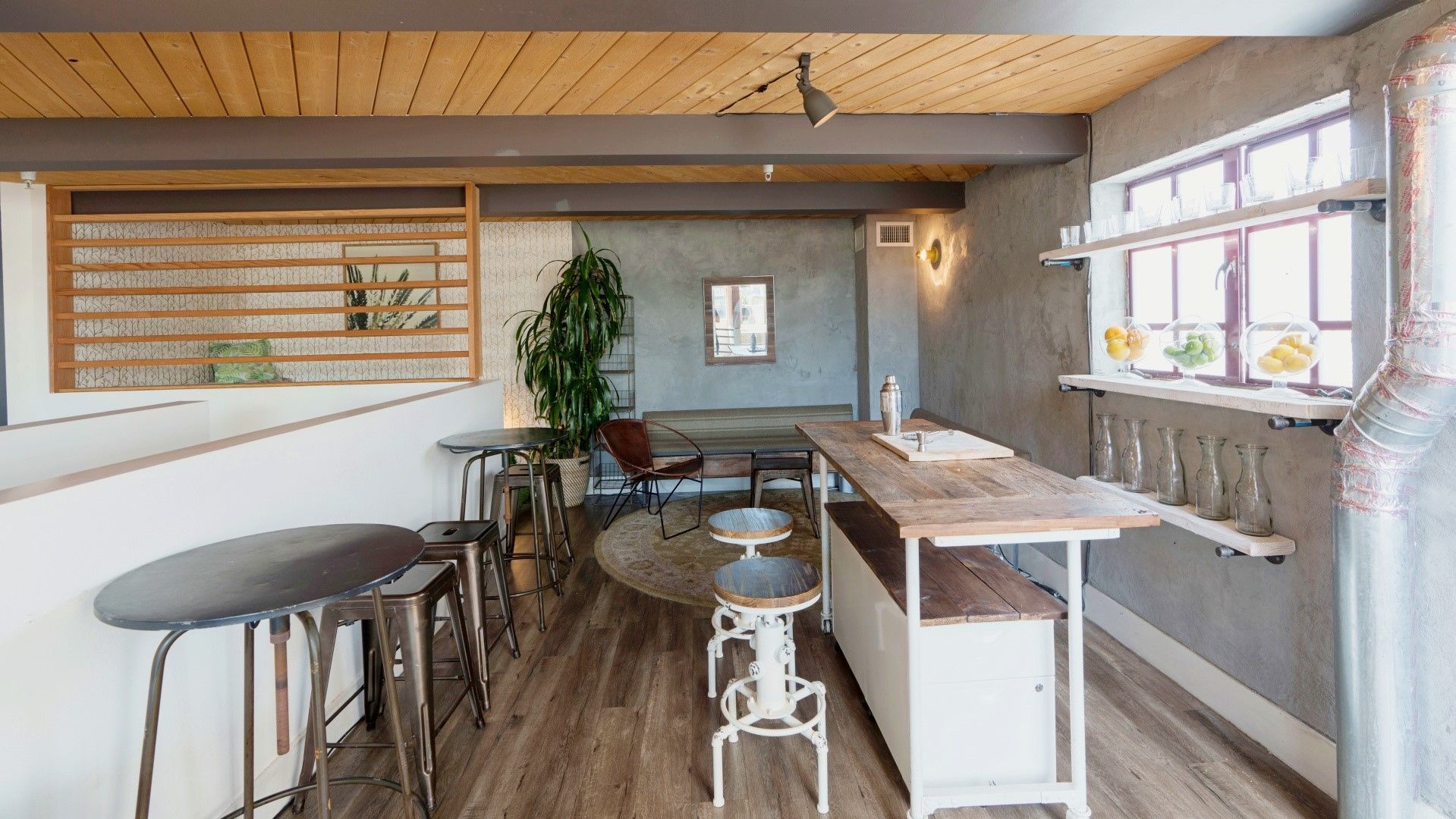 A room with a table and stools in it
