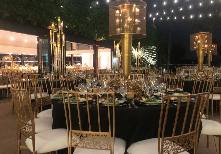 A large room with tables and chairs set up for a party.