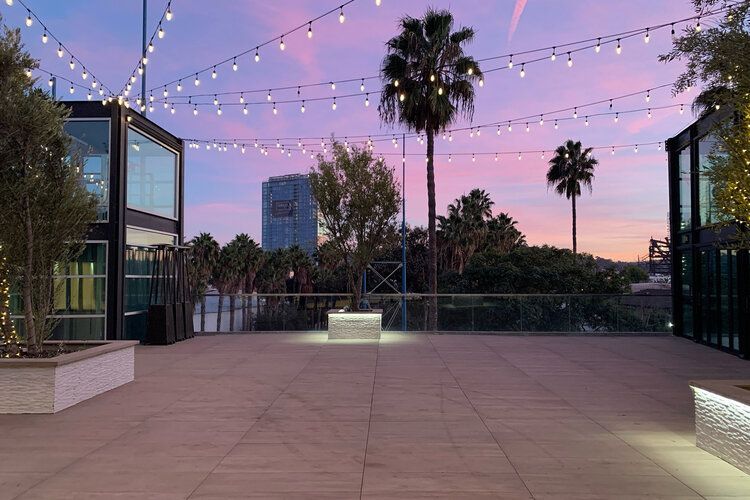A patio with a string of lights hanging from the ceiling