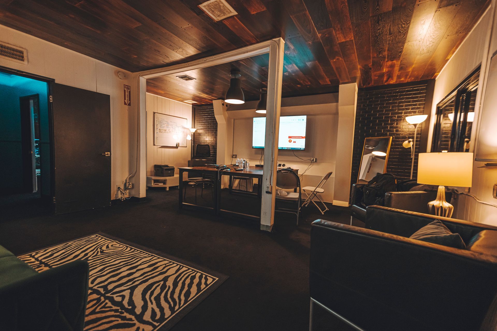 A living room with a zebra print rug and a couch.