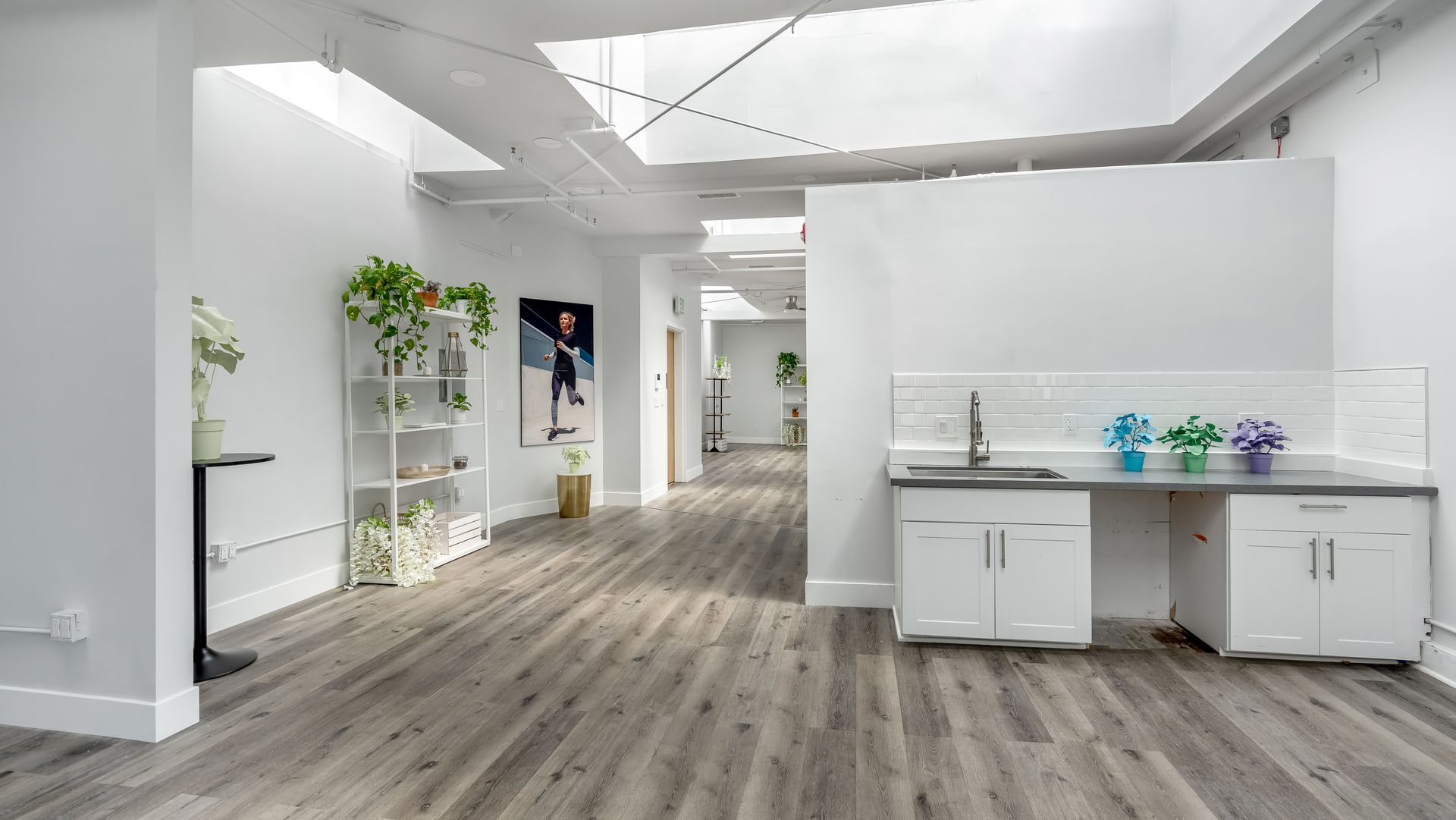 A large room with a sink and cabinets in it